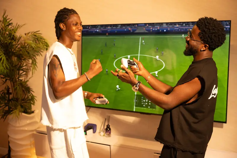 Two men in Bone and Black playing football on the console