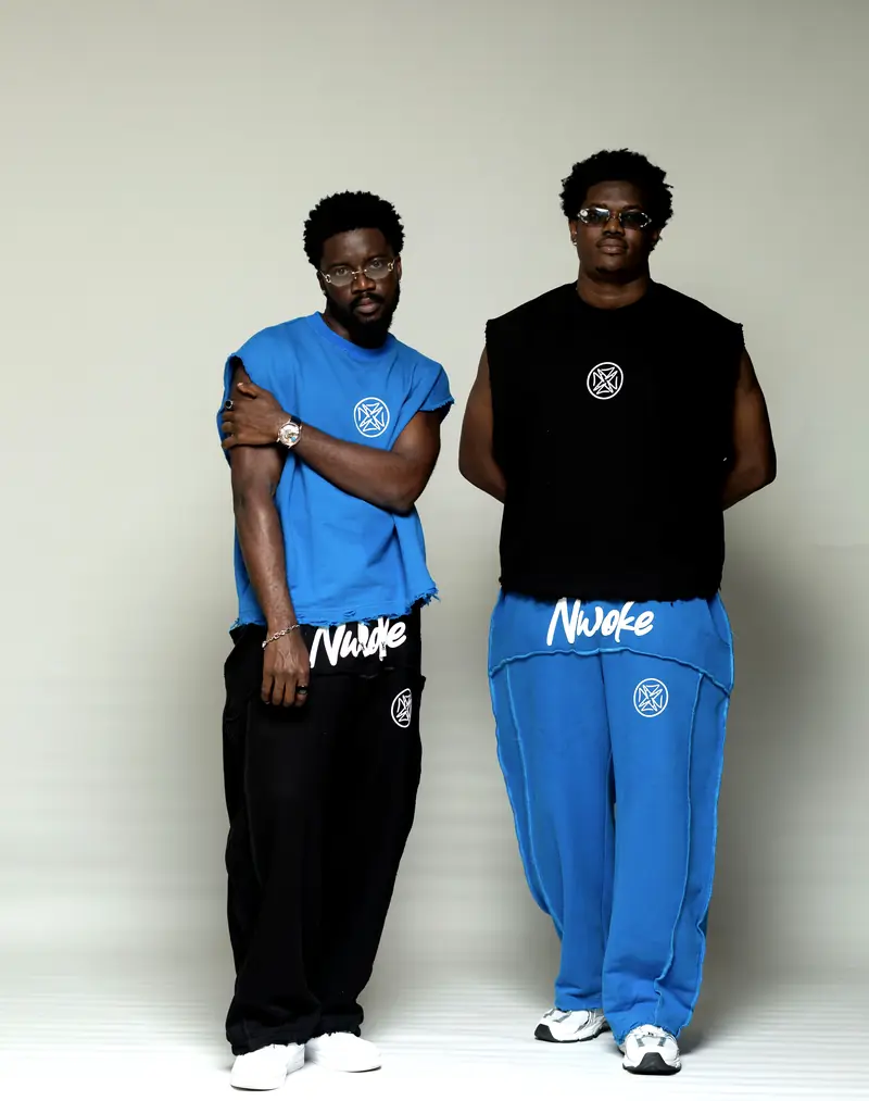 Two men swapping colours: Cobalt top with Black trouser, Black top with Cobalt trouser